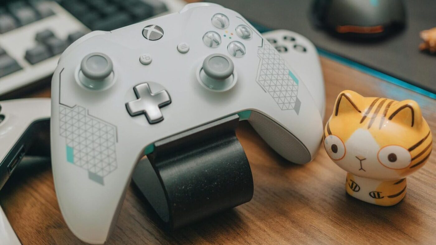 white xbox controller on brown wooden surface